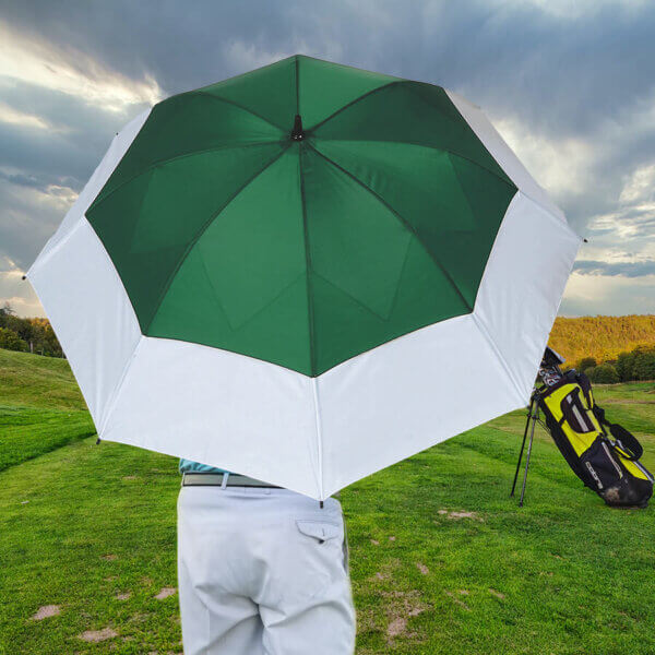 Golfer holding a Big Top umbrella