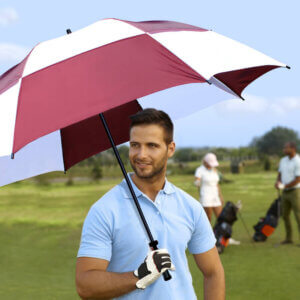 Male golfer holding Super-Sized Checkerboard Windflow Vented Golf Umbrella