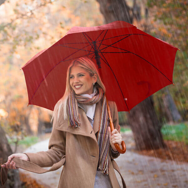 a woman holding Classic Curve Stick Deluxe Umbrella