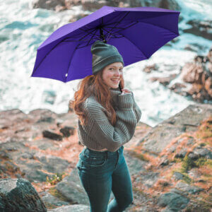 a woman holding purple Classic Tote Folding Umbrella