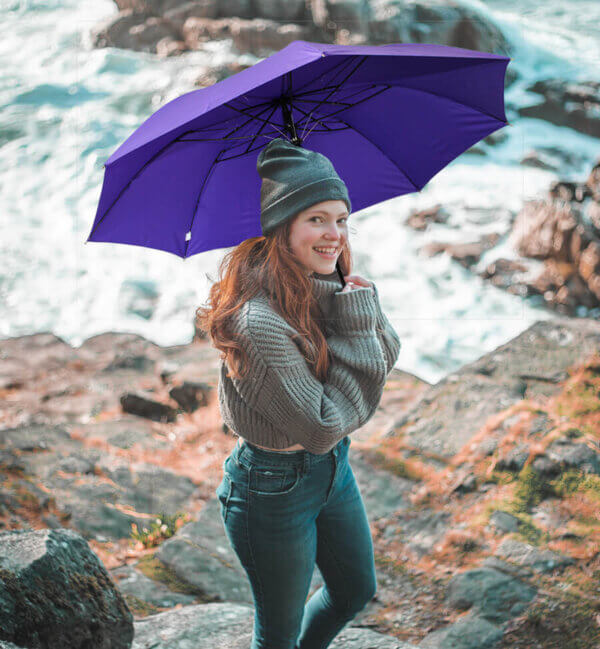 a woman holding purple Classic Tote Folding Umbrella