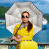 a woman holding an umbrella in the sun