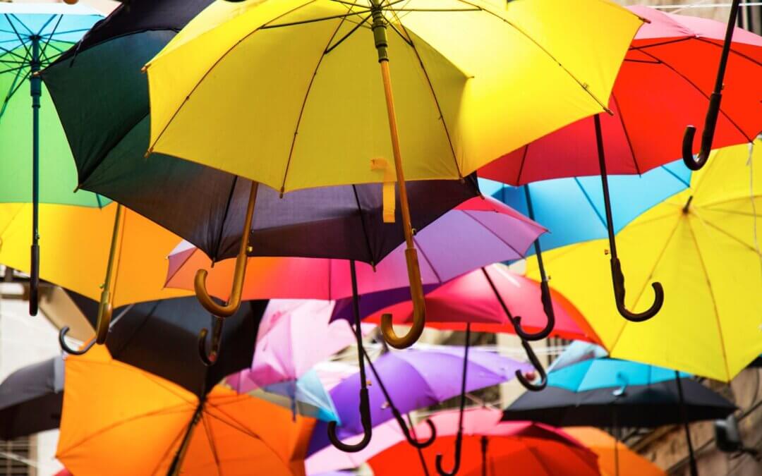 Multiple colorful umbrellas floating.